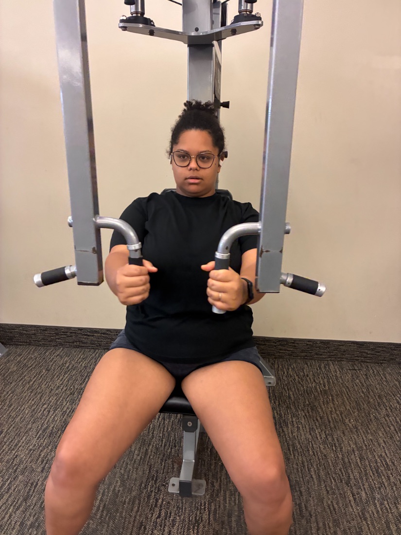 Nicole on a chest press machine