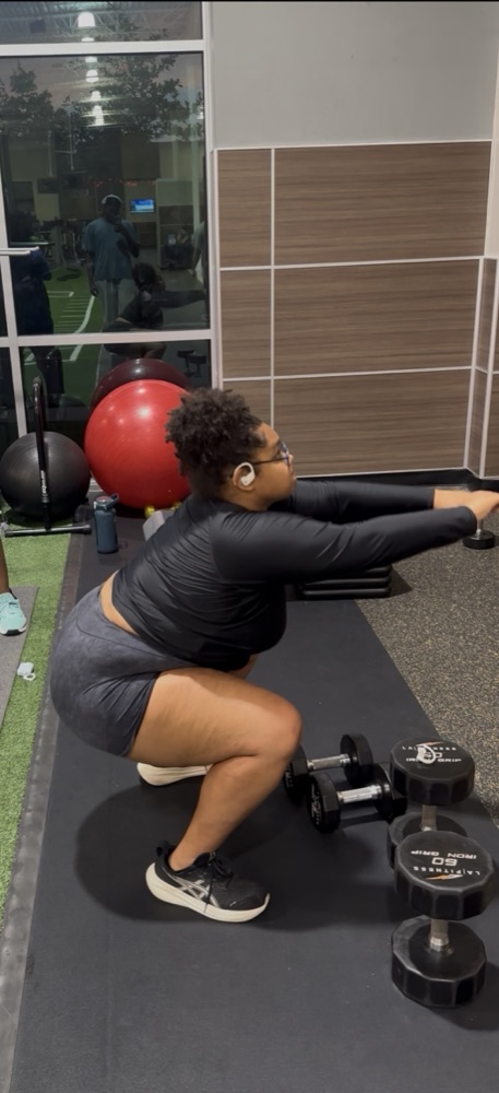 Squats with dumbbells at the gym