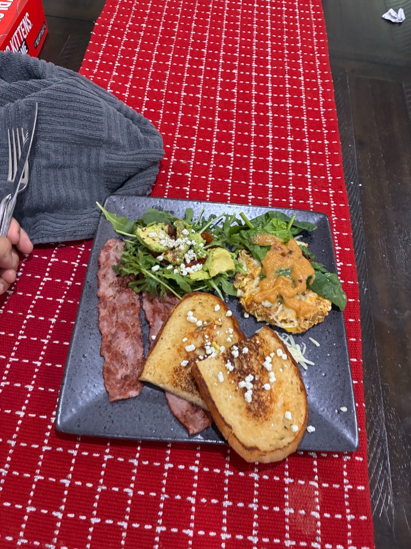 Toast, arugula salad and turkey bacon on a gray plate
