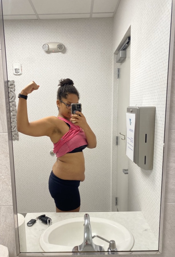 Nicole in 2021, flexing in a gym mirror after a workout